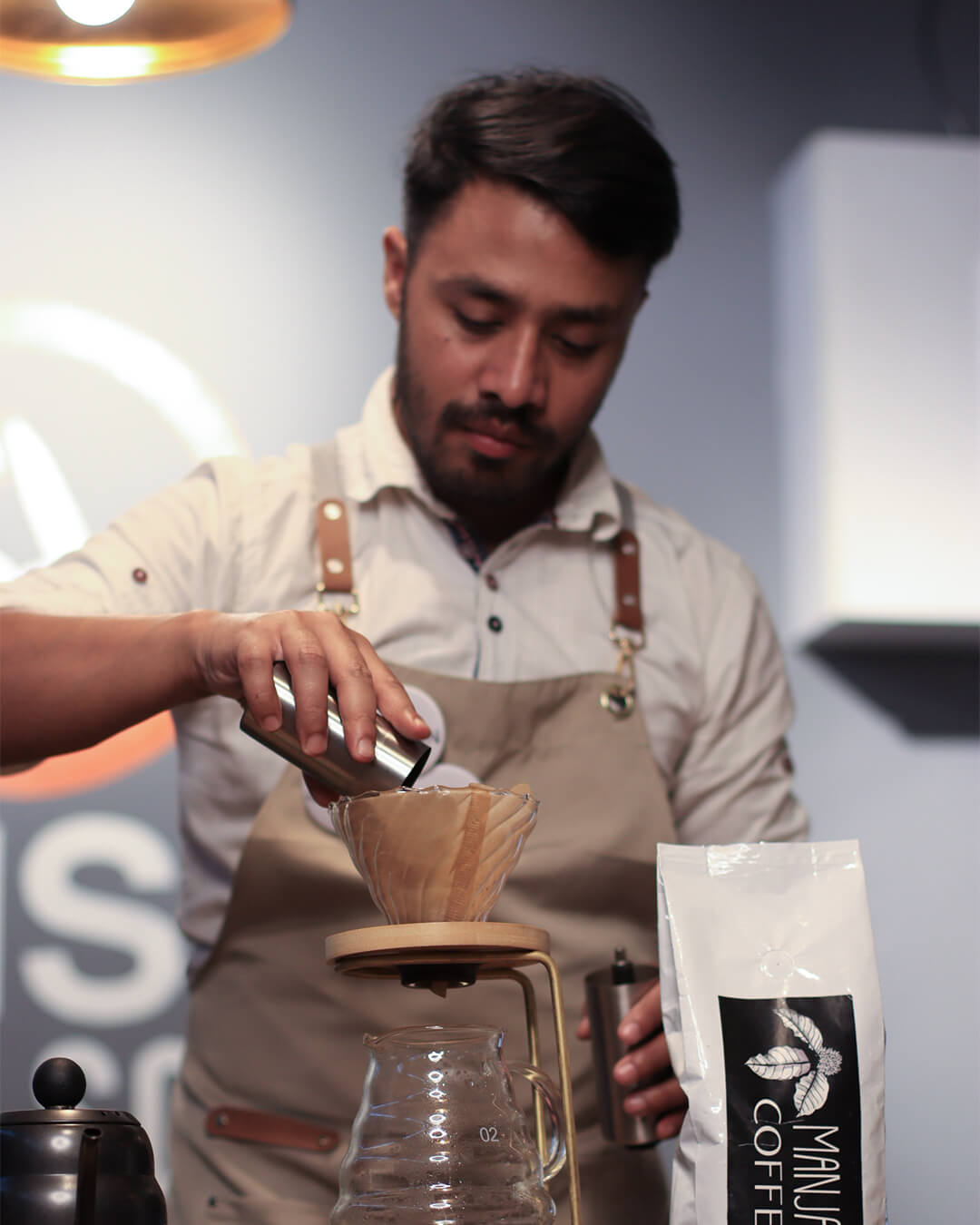 barista making pour over coffee